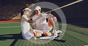 Woman and man playing tennis on a sunny day