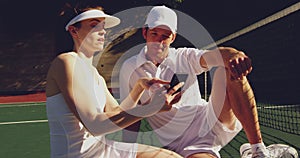 Woman and man playing tennis on a sunny day