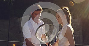 Woman and man playing tennis on a sunny day