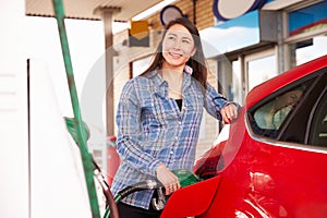 Woman man refuelling a car at a petrol station