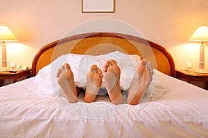 Woman and man rest on soft big bed