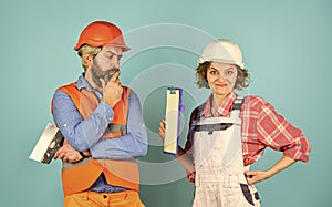 Woman and man safety hard hat. Discussing renovation with contractor. Sign contract with workers. Price list. Couple