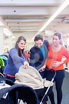 Woman, man, and sales lady in baby store