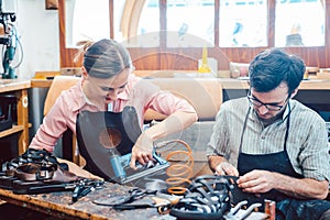 Woman and man shoemaker working together