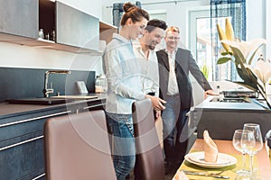 Woman and man shopping for a kitchen and other furniture