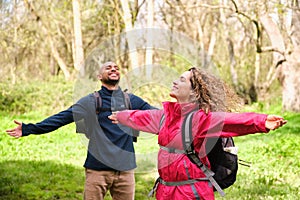 A woman and a man are standing in a forest, breathing and enjoying the moment.