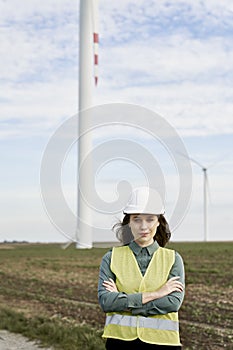 Woman and man standing on wind turbine field