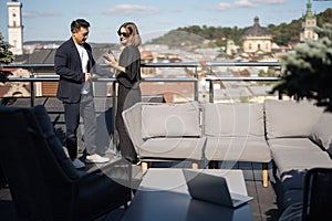 Woman and man take selfie on smartphone on balcony