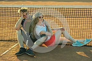 Woman and man tennis players with racket