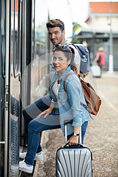 woman and man traveller entering train