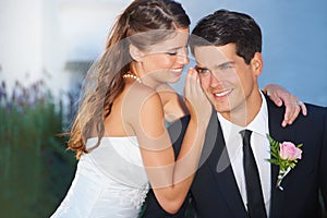 Woman, man and whisper at wedding, smile and thinking outdoor with secret, story and love with romance. Couple, marriage
