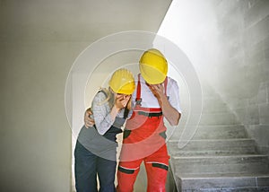 Woman and man workers suffocating at the construction site.