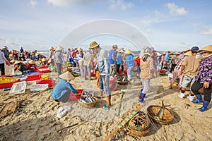 Woman and man working on the beach near Long Hai fish market