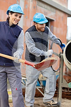 woman and man working hard on construction site