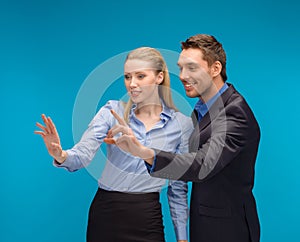 Woman and man working with virtual screen