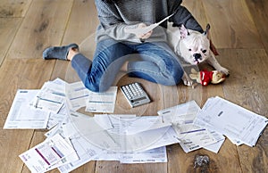 Woman managing the debt sitting beside pet dog