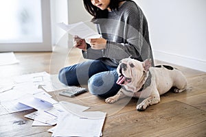 Woman managing the debt sitting with pet dog