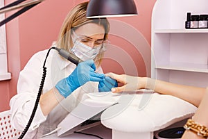 Woman on manicure treatment in beauty salon. Manicure, beauty procedures and personal care. Portrait