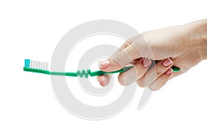 Woman manicured hand holding a toothbrush on white background