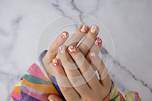 Woman manicured hands, stylish summer colorful nails. Closeup of manicured nails of female hand. Summer style of nail