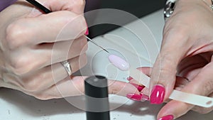 Woman manicurist hand applying gel nail polish