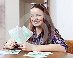 Woman with many euro in home