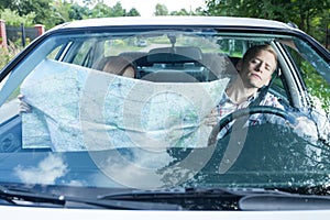 Woman with a map in car