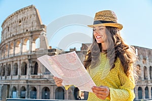 Woman with map in front of colosseum in rome