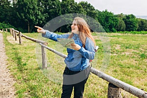 Woman with map hiking in woods. Freedom and active lifestyle concept. Amazing chill moment. Stylish hipster tourist