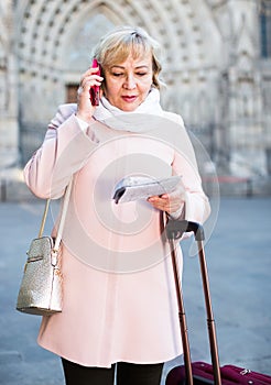 woman with map talking phone