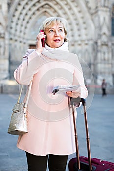 woman with map talking phone