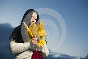 Woman with maple leaves