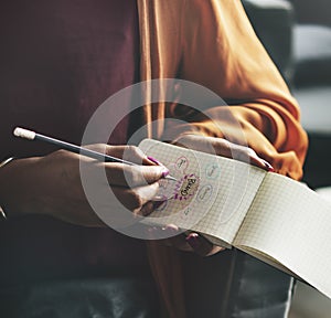 Woman mapping out brand strategies on a notepad