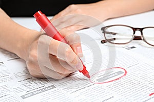 Woman marking advertisement in newspaper. Job search concept