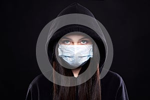 Woman in Mask and Hood. Girl in medicine Mask and Hoodie. covid19