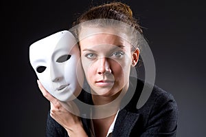 Woman with the mask in hypocrisy concept photo