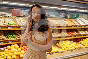 Woman with mask safely shopping for groceries amid the coronavirus pandemic