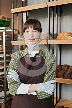 Woman in mask selling fresh bread