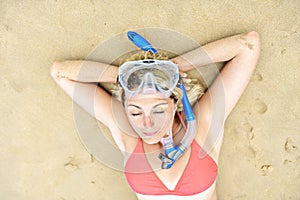 Woman lay with mask for snorkling at the seaside photo