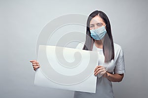 Woman with mask and white sign photo