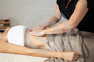 Woman massage body shaping massages girl lymphatic drainage in manual massaging belly in center spa