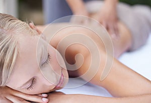 Woman, massage therapist and spa for treatment, back and sleeping for wellness and stress relief therapy. Face, masseuse