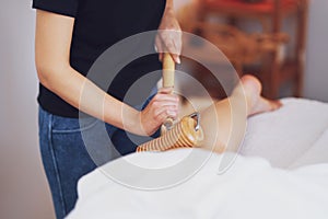 Woman at massage therapy with wooden tools