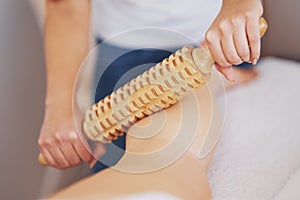 Woman at massage therapy with wooden tools