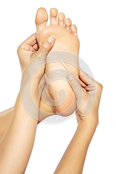 Woman massaging her foot on white background