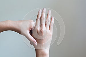 Woman massaging her painful hand. Healthcare and medical concept