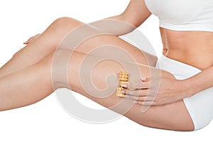 Woman Massaging With Wooden Massager photo