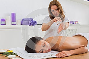 Woman massagist make body massage in spa wellness center