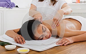 Woman massagist make body massage in spa wellness center photo