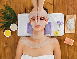 Woman massagist make face lifting massage in spa wellness center photo